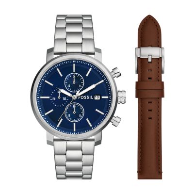 A men’s silver-tone watch with a navy blue dial and an interchangeable brown leather strap.