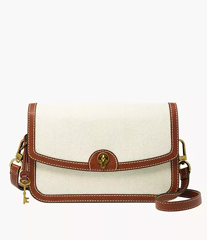 A women’s crossbody handbag in white linen with brown trim.