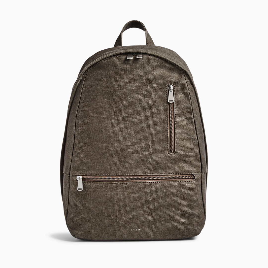 The Krøyer backpack's zip-closure interior features a padded sleeve large enough for a 15-inch laptop along with two slip pockets, two mesh zip pockets and a pen holder. A zippered through pocket on the back allows earbuds to extend through even when closed. The exterior also features easily accessible vertical and horizontal zip pockets. Carry it via the single leather grab handle or by its two adjustable webbing straps.