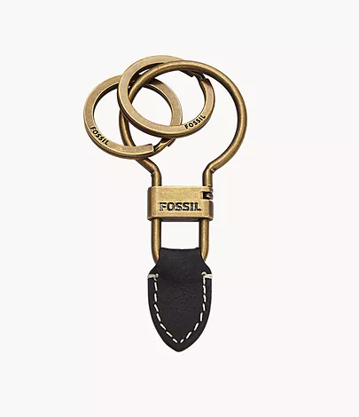A keyfob with a brass ring and black leather arrow detail.