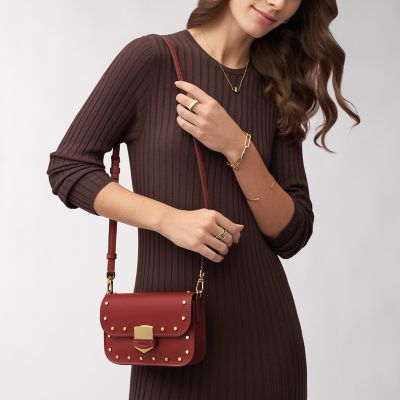 Close up of fashionable elegant woman`s outfit: trendy small shoulder bag,  stylish wrist watch, beautiful ring with red gem. Copy, empty space for  text Stock Photo
